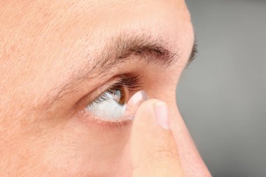 Onun gözünde, closeup koyarak Kontakt lens genç adam