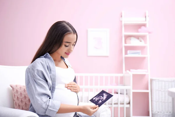 妊娠中の女性が自宅の超音波画像を見て — ストック写真