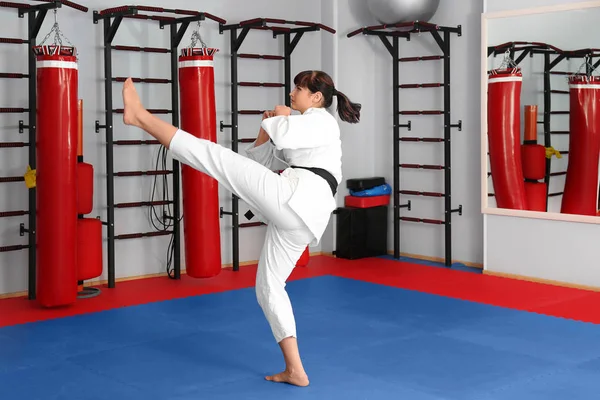young female karate instructor in dojo