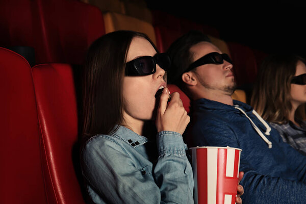 Young people watching movie in cinema