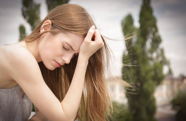 Depressed young woman on balcony