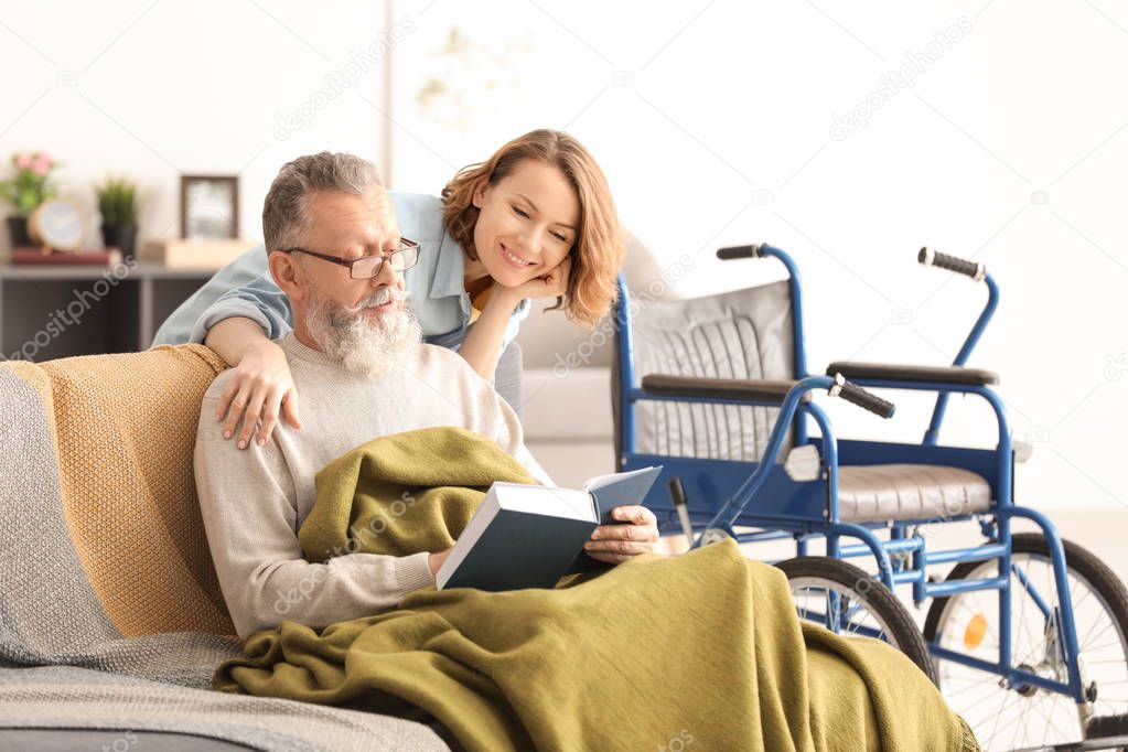 Senior man with young caregiver