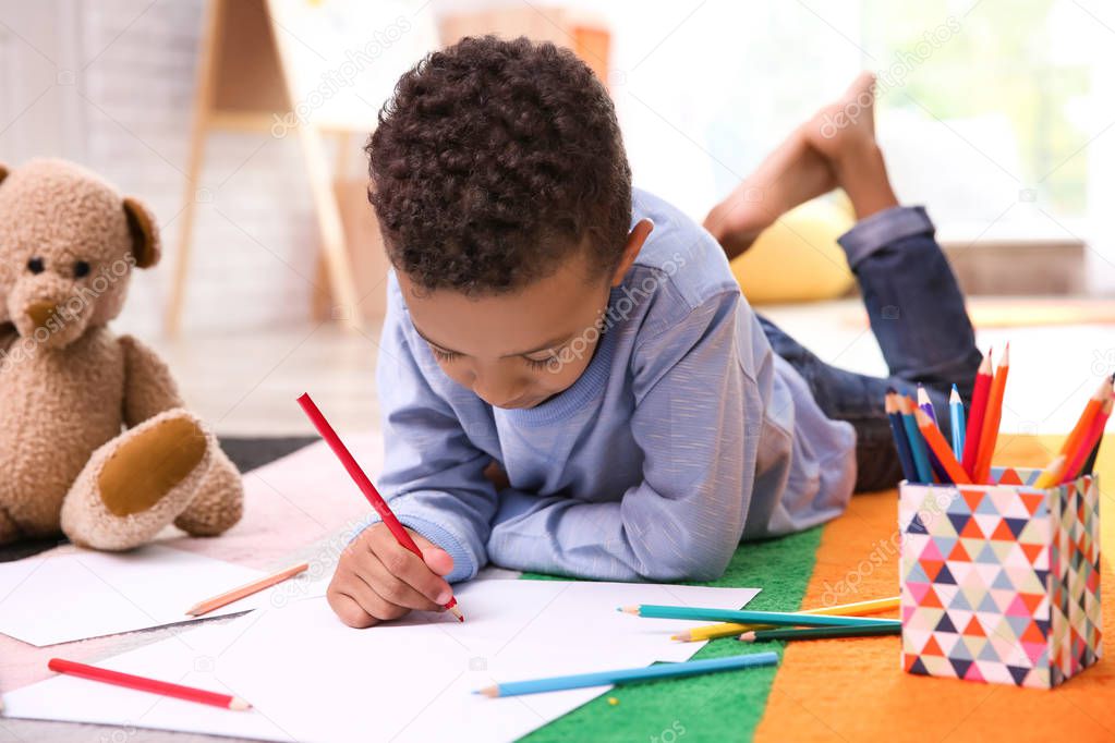 Little African-American boy drawing  