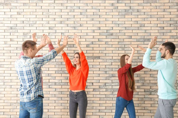 People giving high five, indoors. Unity concept