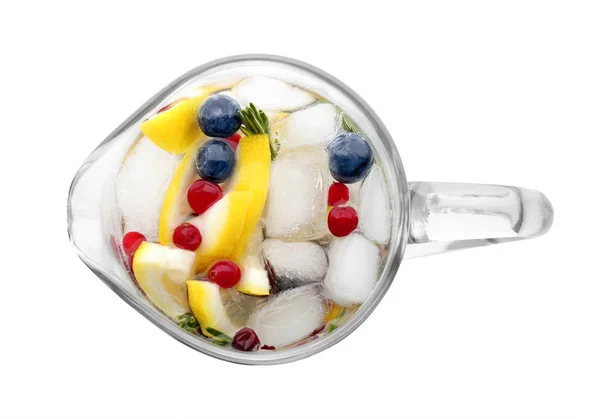 Glass jug of cold lemonade with berries — Stock Photo, Image