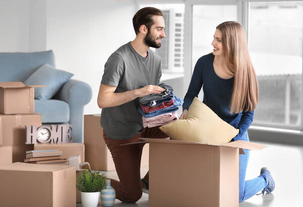 Young couple packing belongings 