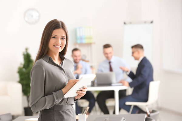 Young smiling businesswoman with tablet