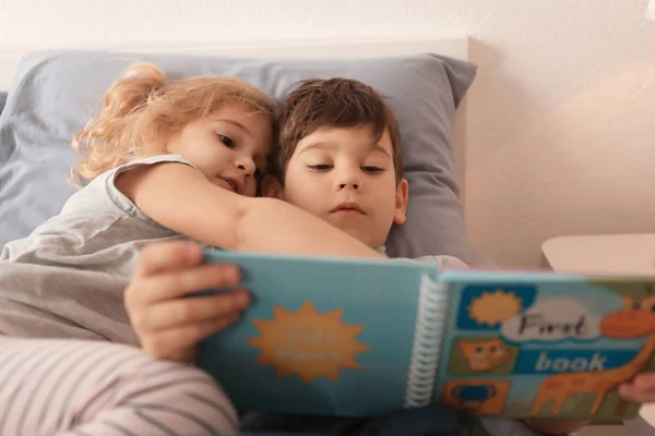 Söta barn läsa godnattsaga — Stockfoto