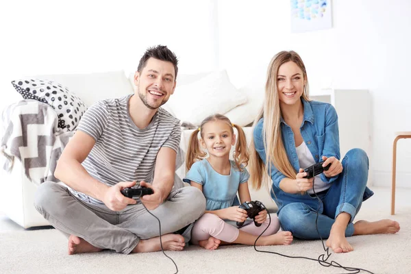 Happy family playing video games at home