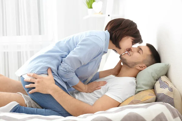 Happy Young Couple Kissing Bed — Stock Photo, Image