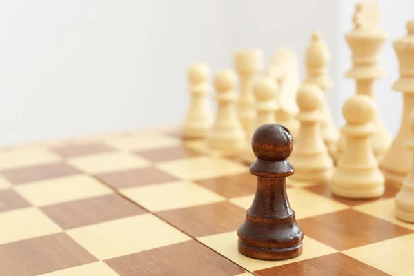 Wooden chess figures and one different on board — Stock Photo, Image