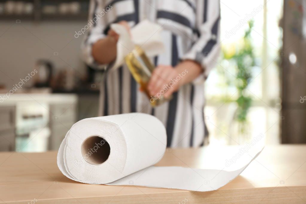 Roll of paper towels and blurred woman on background