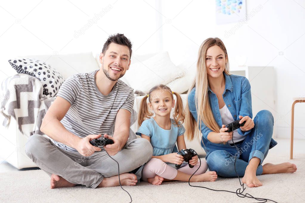 Happy family playing video games at home