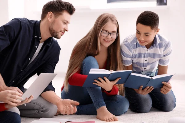 Teenagers doing homework with teacher — Stock Photo, Image