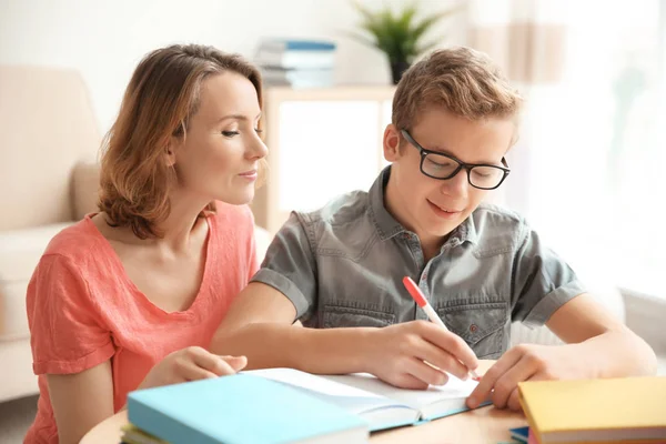 Teenager with mother doing homework