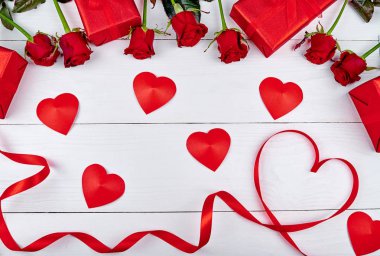 Üstten Görünüm kırmızı gül, hediye kutuları ve şerit olarak beyaz ahşap arka plan, kopya alanı üzerinde kalp şeklinde. Tebrik kartı mockup Sevgililer günü, Womans gün, düz yatıyordu. Aşk kavramı