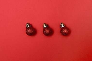 Kırmızı arka planda kırmızı parlak mücevherleri olan yaratıcı Noel deseni