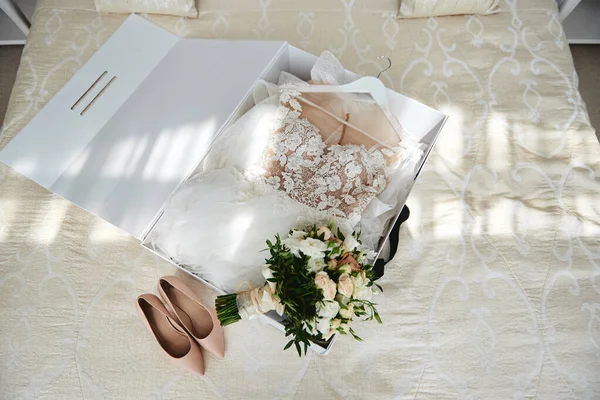 Роскошное свадебное платье в белой коробке, бежевая женская обувь и брида — стоковое фото