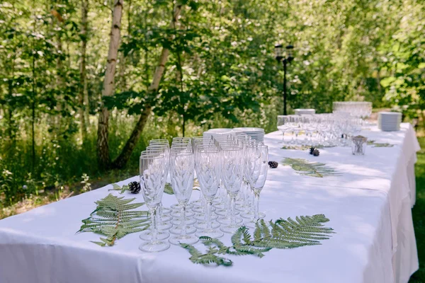 Sparkling glassware on dinner table in restaurant outdoors, copy