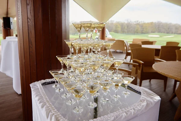 Stack of champagne glasses on table on wedding party reception o