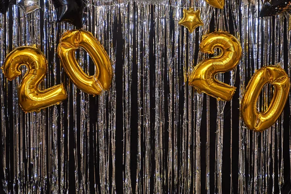 New year photo zone with gold, black and silver balloons and foi
