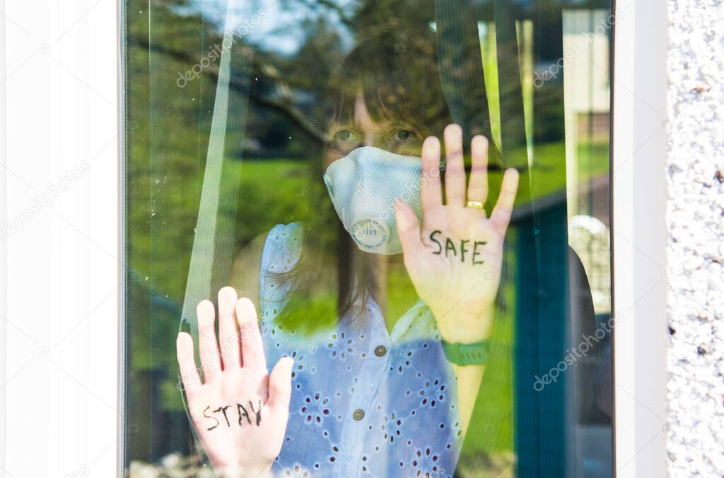 Woman with medical face mask Quarantine during Coronavirus pandemic. UK