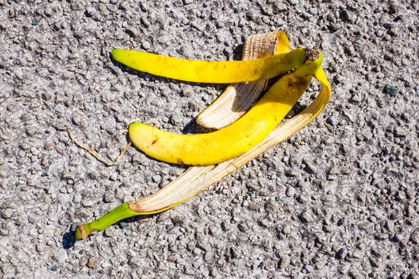 slippery banana peel laying on ground ready to make someone slip and fall UK