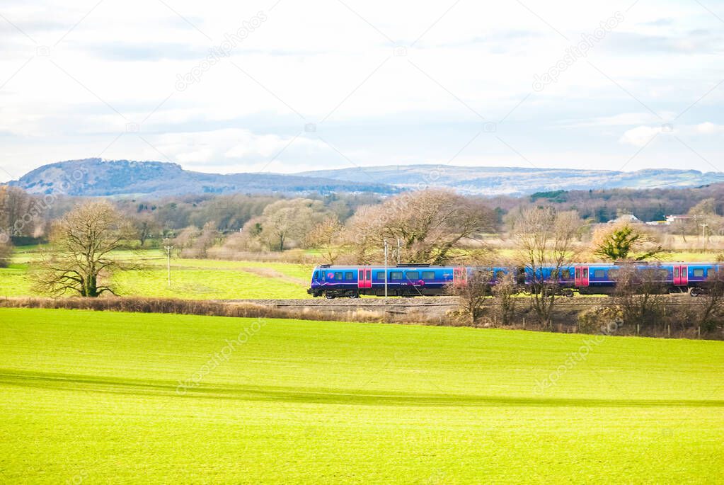A TransPennine Express passenger train in the countryside