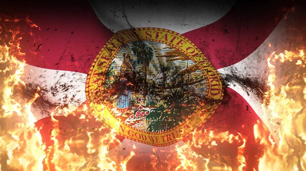 Florida US State grunge war flag waving on fire. United States of America Florida dirty conflict flag on inferno flames blowing on wind.