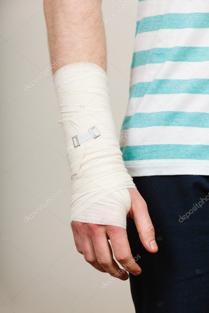Part body man with bandaged hand.