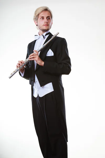 Male flutist wearing tailcoat holds flute — Stock Photo, Image