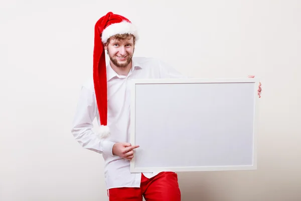 Homem de chapéu de Pai Natal com banner em branco. Espaço de cópia . — Fotografia de Stock