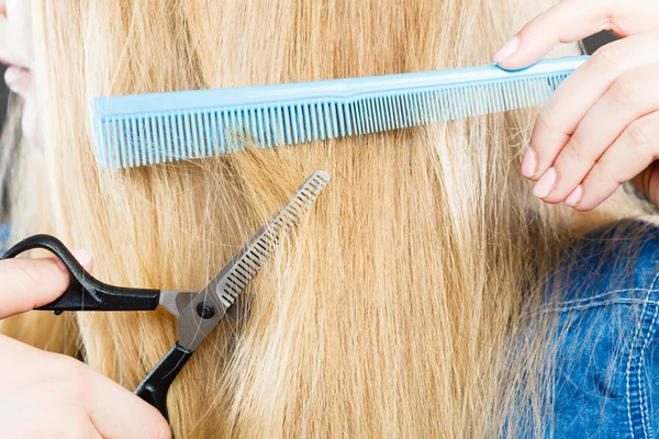 Woman cutting down smoothy hair.