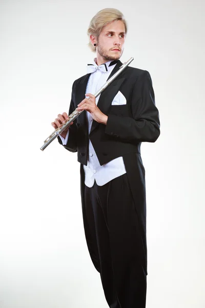 Male flutist wearing tailcoat holds flute — Stock Photo, Image