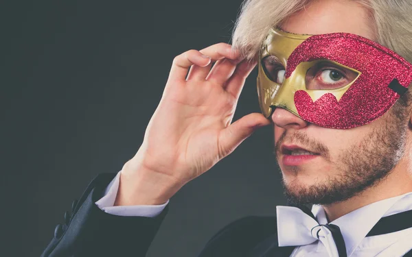 Young man in carnival mask on dark — Stock Photo, Image