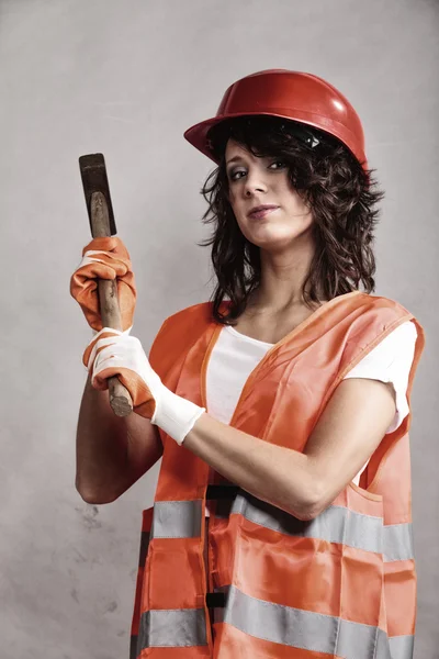 Sexy girl in safety helmet holding hammer tool