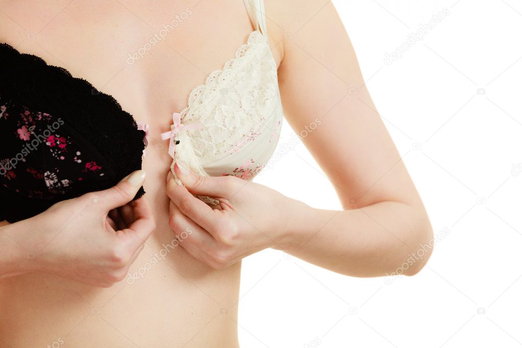 Lady with choice trying to choose perfect bra. Stock Photo by