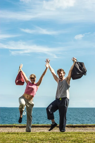 Happy couple man and woman with sport bags. — Stock Photo, Image
