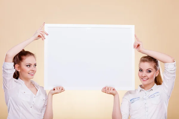 Two girls with blank presentation board — Stock Photo, Image