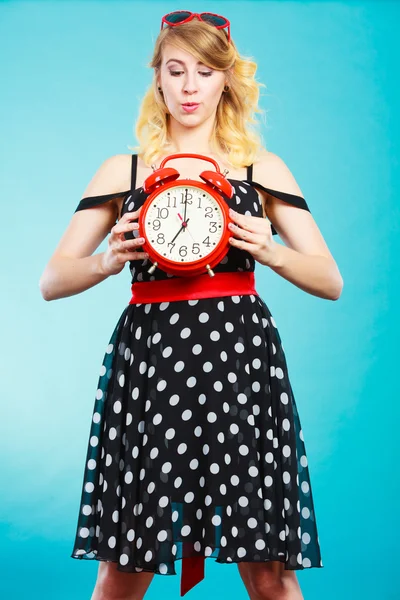 Blonde girl with alarm clock on blue. — Stock Photo, Image