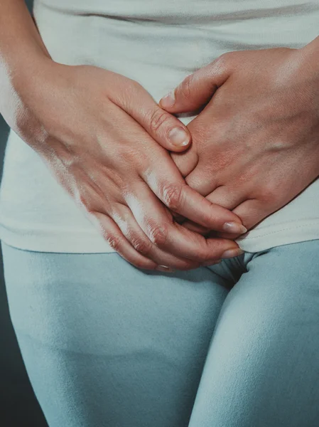 Woman with hands holding her crotch — Stock Image Woman with hands holding her crotch Stock Picture
