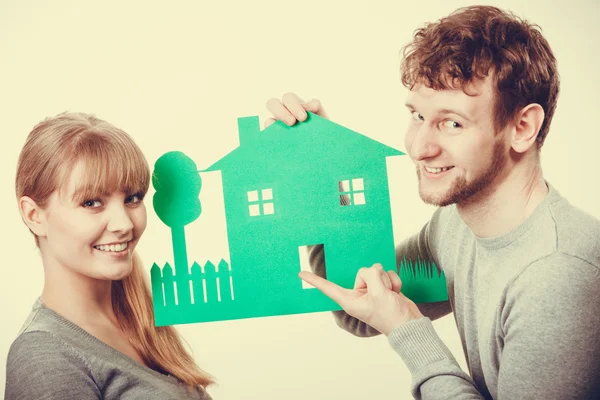 Young couple with ecological green house.