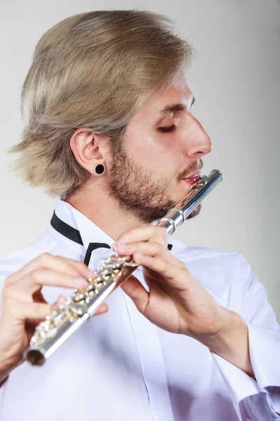 Male flutist playing his flute — Stock Photo, Image