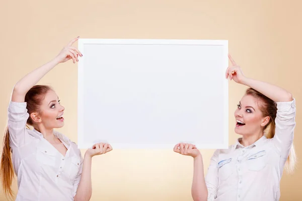 Two girls with blank presentation board — Stock Photo, Image