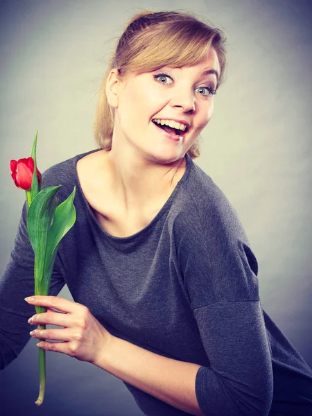 Glückliche blonde Frau mit Frühlingsblume. — Stockfoto