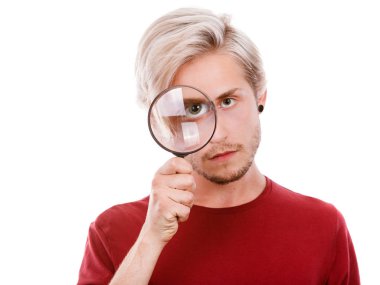 man holds on eye magnifying glass looking through loupe clipart