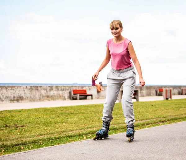 Mujer joven activa patinaje al aire libre . — Foto de Stock