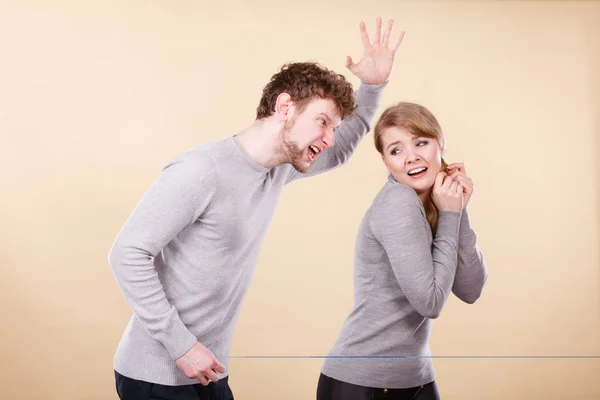 Aggressive man yelling on woman.