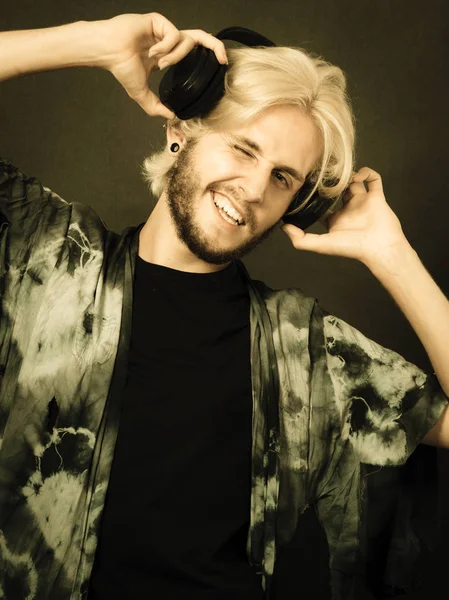 Blonde man singing in studio wearing headphones — Stock Photo, Image