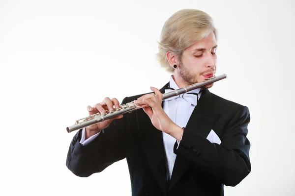 Male flutist wearing tailcoat plays flute — Stock Photo, Image
